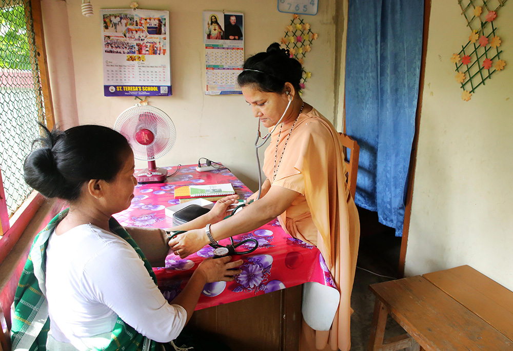 Our Lady of the Missions Sr. Benedicta Pereira is pictured treating a patient at their dispensary. Pereira works as the head teacher of the school in Bolipara Parish, a remote area in the hilly Bandarban district. (Stephan Uttom Rozario)