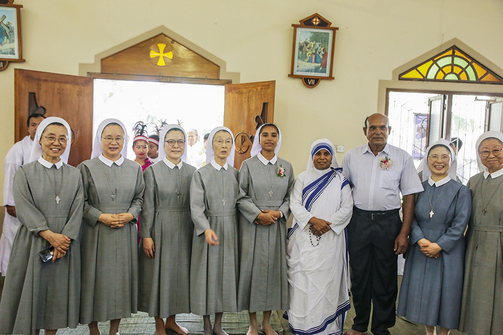 Sr. Teagon Andre Maria, center, poses for a photo with her fellow Sisters of Charity of St. Vincent de Paul, along with her father and her aunt, a Missionaries of Charity sister. (GSR photo/Stephan Uttom Rozario)