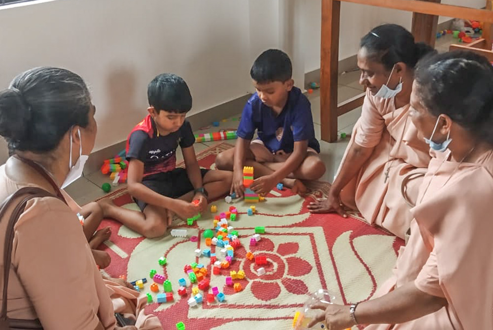 Sr. Linet Sebastian (right), of the Ursuline Sisters Daughters of Mary Immaculate, conducts relaxation therapy for children affected by the landslides in Wayanad, Kerala, southwestern India. (Courtesy of Linet Sebastian)