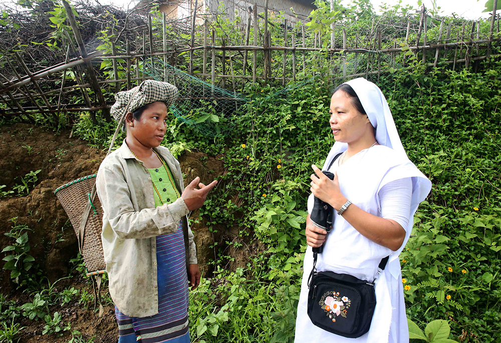 Sr. Elizabeth Tripura consults with a woman. (Stephan Uttom Rozario)