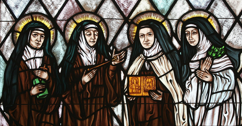 St. Therese of Lisieux is featured holding an image of the Holy Face in this stained glass depiction of beloved female saints in the church of St. Therese, Montauk, New York. Illustrated are Sts. Teresa Benedicta of the Cross, Teresa of Avila, Therese of Lisieux and Catherine of Siena. (OSV News/Gregory A. Shemitz)