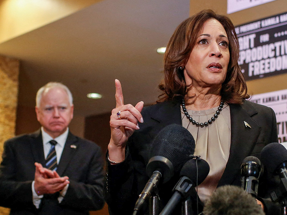 Minnesota Gov. Tim Walz looks on as Vice President Kamala Harris speaks as she visits an abortion clinic in Minneapolis March 14. (OSV News/Reuters/Nicole Neri)