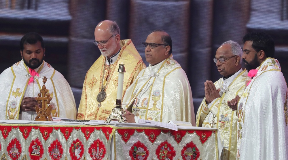 Bishops and other clergy stand around altar during liturgy; all vested. 