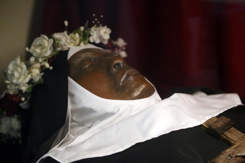 Close up of the exhumed nun's face, wearing habit and crown of roses. 