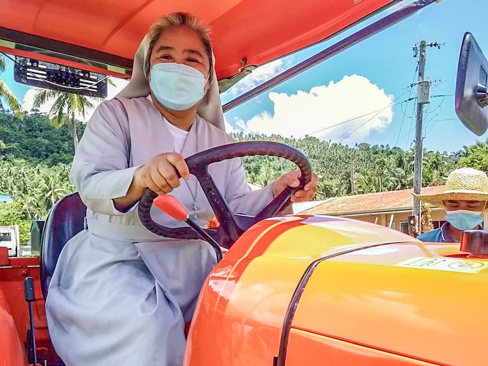 Sr. Ailyn Cayanan drives a four-wheeled tractor at Mary Help of Christians School - Mindoro Inc., while teaching rice machinery operation for national certification. (Courtesy of Ailyn Cayanan)