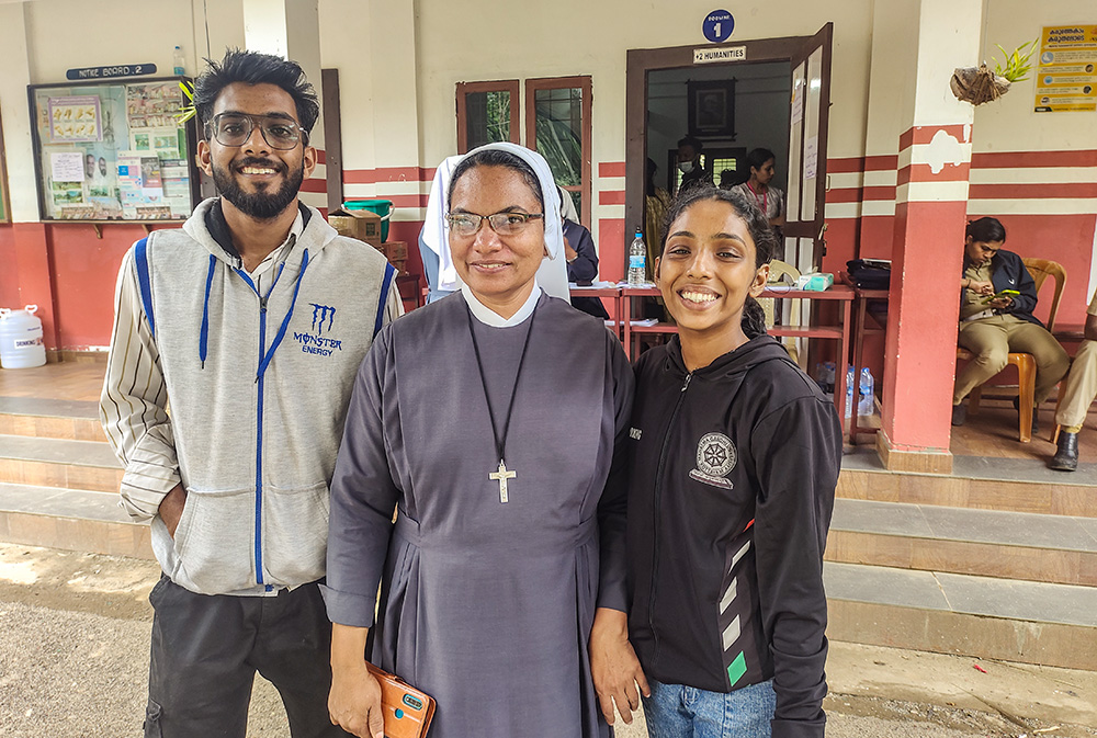 Maria Bambina Sr. Joicy Joseph, principal of the St. Joseph's Higher Secondary School, poses for a photo with two Jesus Youth volunteers, Jacob Sebastian (left) and Twinkle John (right). They were serving the residents of relief camps set up in the school at Meppadi, a town in the Wayanad district of the southwestern Indian state of Kerala. (Thomas Scaria)