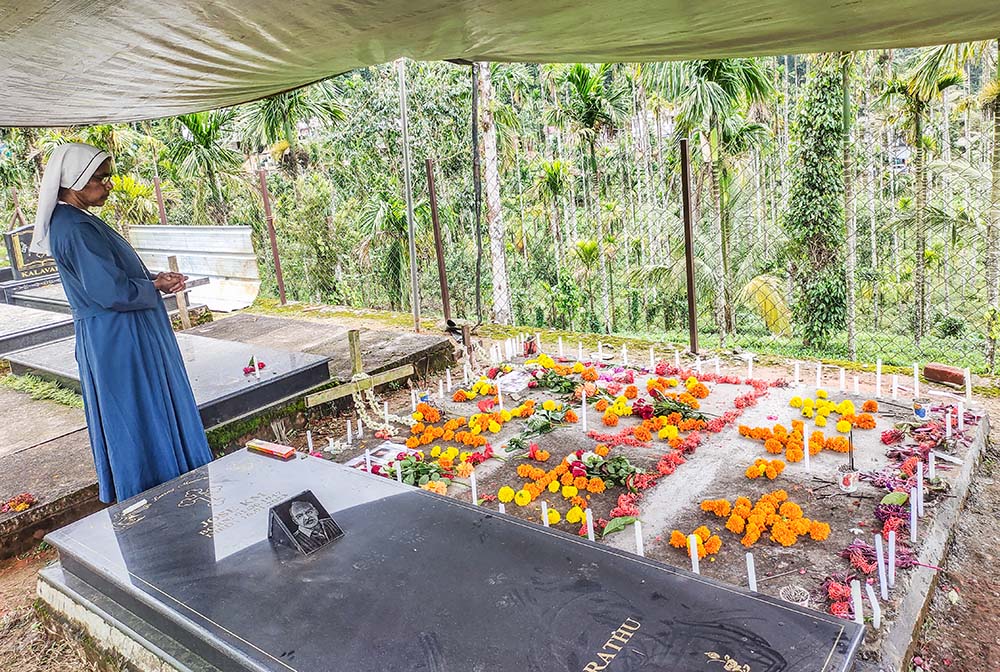 Maria Bambina Sr. Sherly Joseph prays at the mass grave of St. Sebastian Church, Chooralmala, one of the villages in Wayanad, Kerala. (Thomas Scaria)