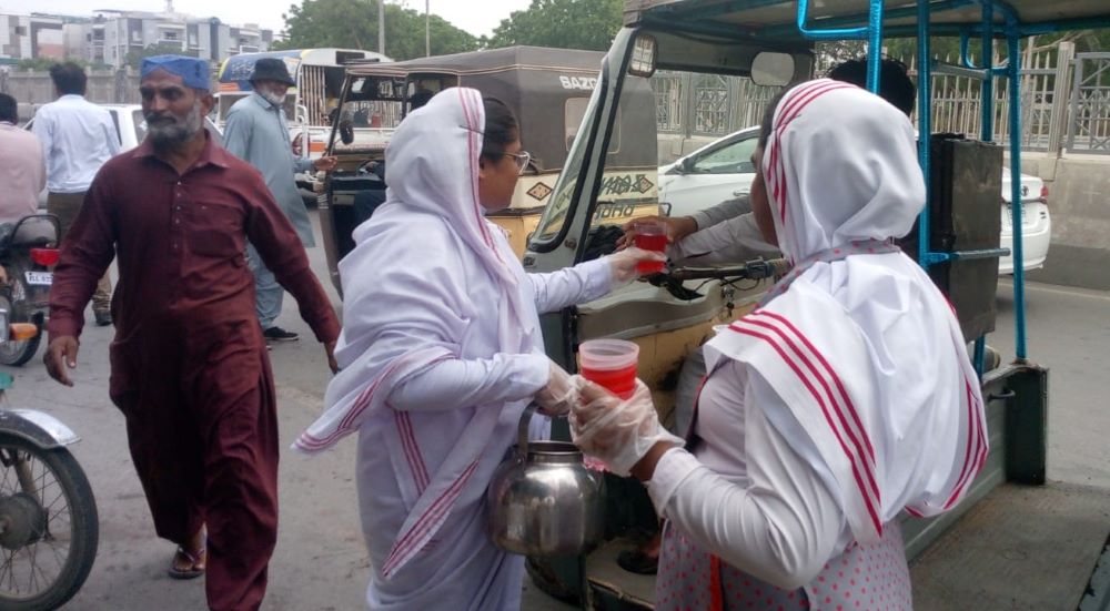 Franciscan Missionaries of Christ the King distribute cool drinks.