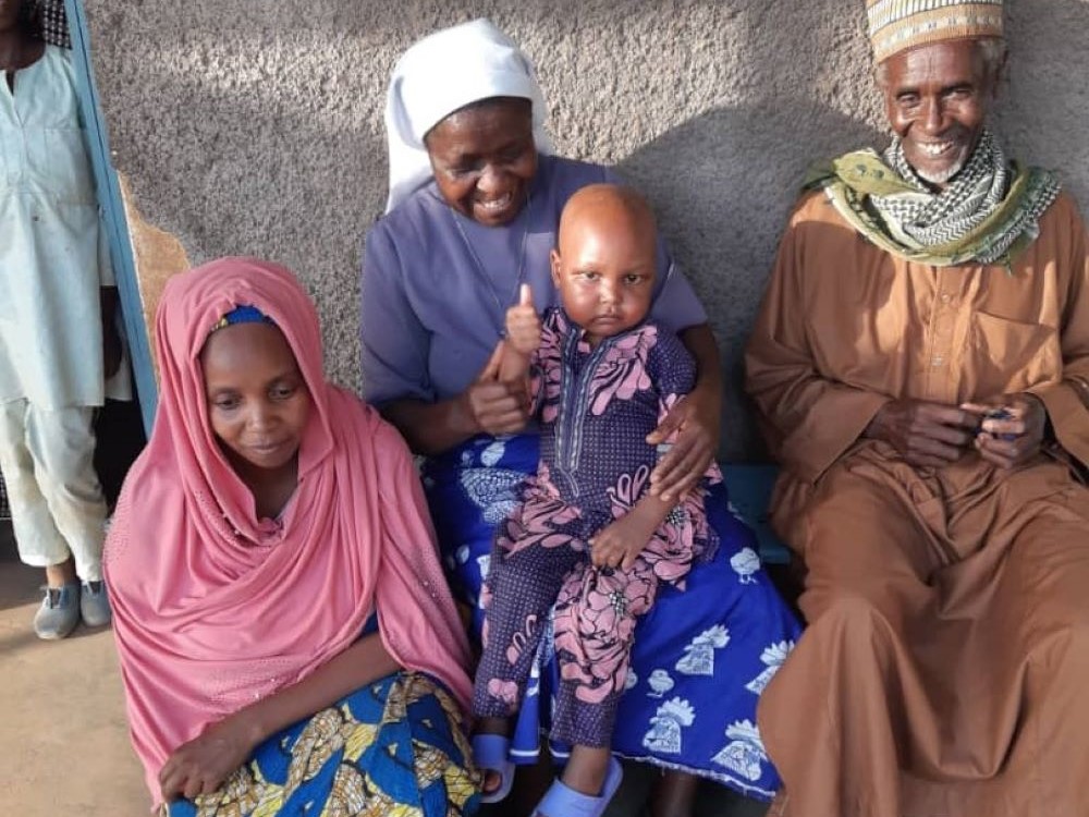 Mohan with his parents and Sr. Felicitas Asoh