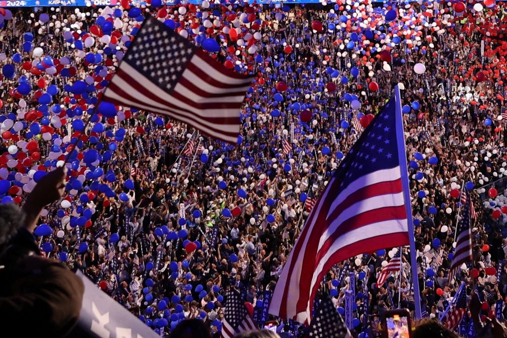 U.S. flags and balloons fill the United Center after Vice President Kamala Harris speaks at convention. 