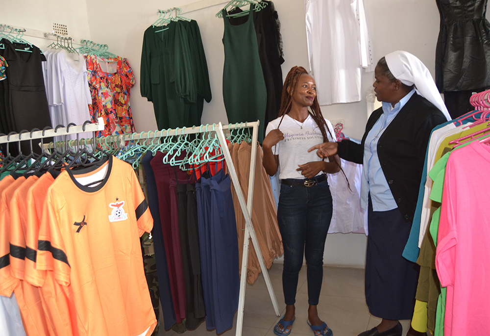 Christabel Songiso, a former student of Holy Cross Girls Secondary School, interacts with Sr. Bibian Mbao in her boutique in Mongu, Zambia. (Derrick Silimina)