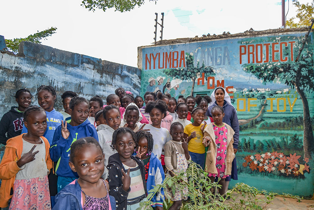 Immaculate Conception Sr. Theresa Kulandai poses for a picture with orphaned girls at Home of Joy, also known as Nyumba Yanga Orphanage, located on the grounds of the Marian Shrine in Lusaka, Zambia. (Derrick Silimina)