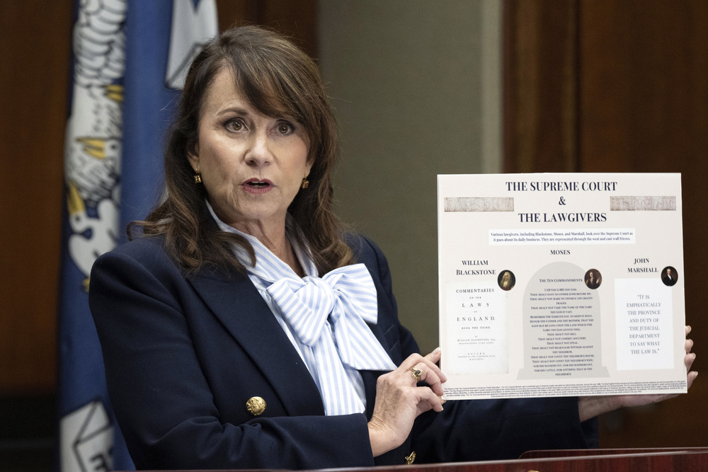 Louisiana Attorney General Liz Murrill, 2024. Murrill holds little poster.
