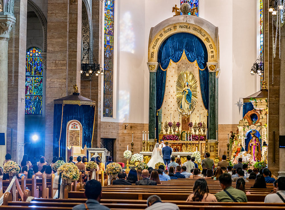 A young Filipino couple is married at the altar of Manila's Cathedral of the Immaculate Conception in the Philippines in 2023. (Dreamstime/Neil Bussey)