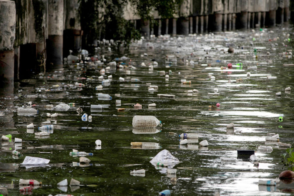 Plastic bottles float on the heavily polluted San Juan River, a tributary of Pasig River in Mandaluyong City, Philippines, June 21, 2021. (CNS photo/Eloisa Lopez, Reuters)