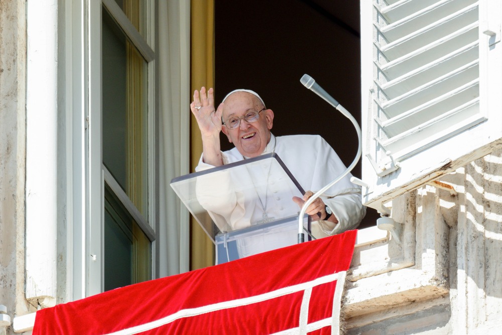 Pope waves from window. 