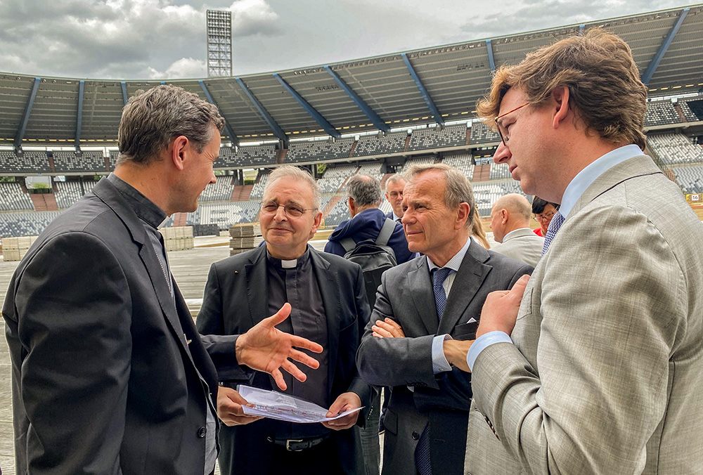 Archbishop Luc Terlinden of Mechelen-Brussels discusses preparations for the Sept. 29 papal Mass at the King Baudouin Stadium in Brussels with Fr. Luc Van Hilst, dean of the basilica in Scherpenheuvel-Zichem, who will be the ceremonialist for the papal Mass; Alexis Brouhns, national coordinator of the papal visit to Belgium; and Bruno Spriet, secretary-general of the Belgian bishops' conference. (OSV News/Courtesy of Patrick du Bois)