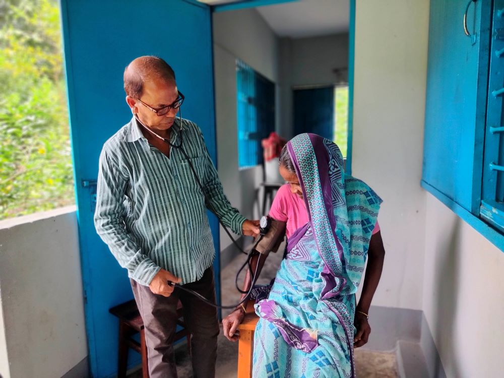 A Holy Cross Health Education Centre staff member checks a patient's blood pressure.nt at the facility in northeastern Bangladesh. (Stephan Uttom Rozario)