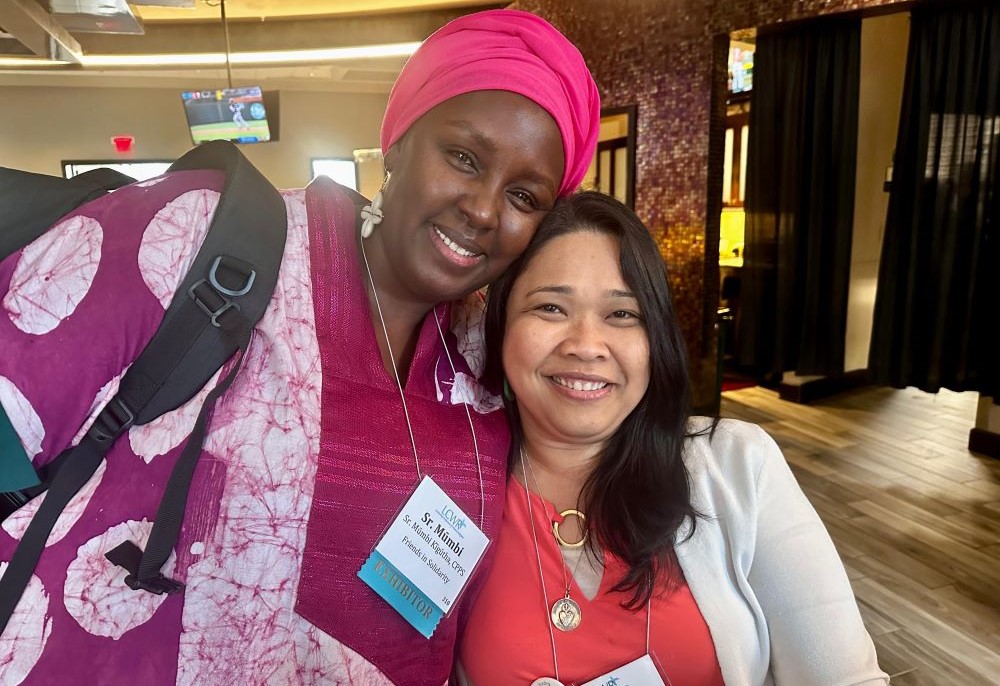 Sr. Mumbi Kigutha and Sr. Romina Sapinoso connect during a break at the Leadership Conference of Women Religious 2024 assembly.