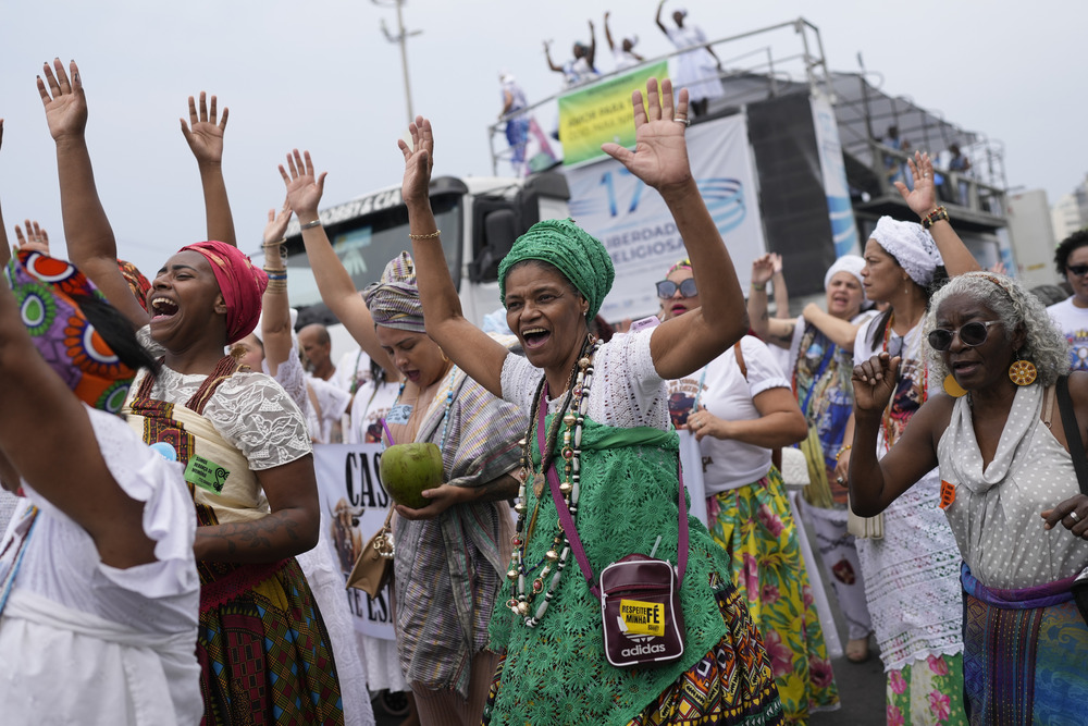 Defense of Religious Freedom march, Rio de Janeiro, Brazil, Sept. 15, 2024. Colorfully garbed women cheer and dance in procession.