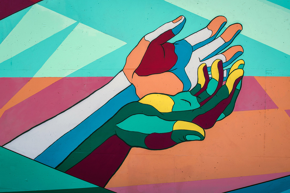 Colorful graphic of two outstretched hands.