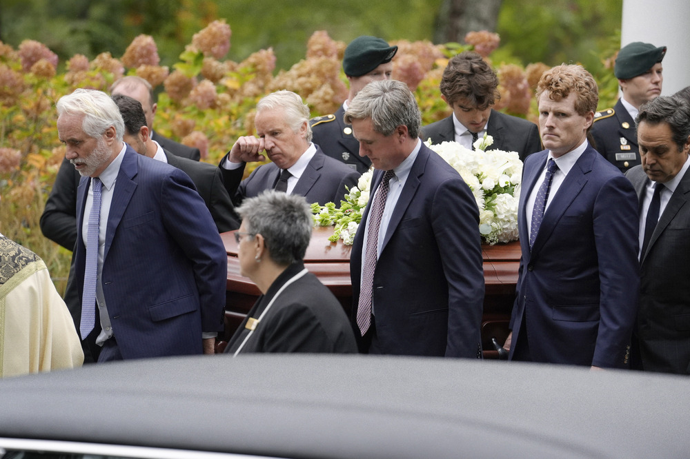 Ethel Kennedy funeral, Centerville, Massachusetts, Oct. 14, 2024. The men walk carrying casket.