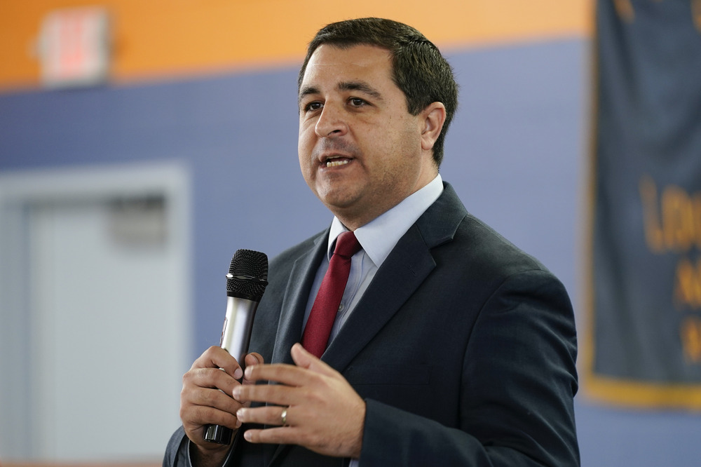 Wisconsin Attorney General Josh Kaul, Milwaukee, Oct. 27, 2022. Kaul stands holding a microphone.