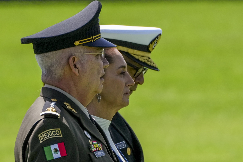 Mexican President Claudia Scheinbaum, Defense Minister Gen. Ricardo Trevilla Trejo, and Navy Secretary Alt. Raymundo Pedro Morales, Mexico City, Oct. 3, 2024. All three stand, shown in profile.
