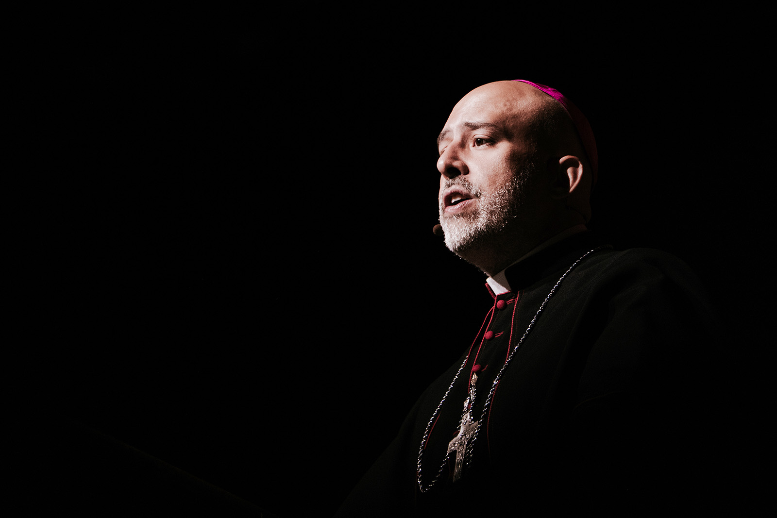 The bishop is shown in sharp chiaroscuro. 