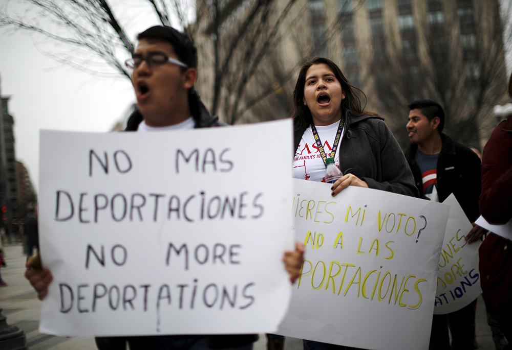 Demonstrators call for an end to deportations in a protest outside the White House in Washington in 2016. (CNS/Reuters/Carlos Barria)