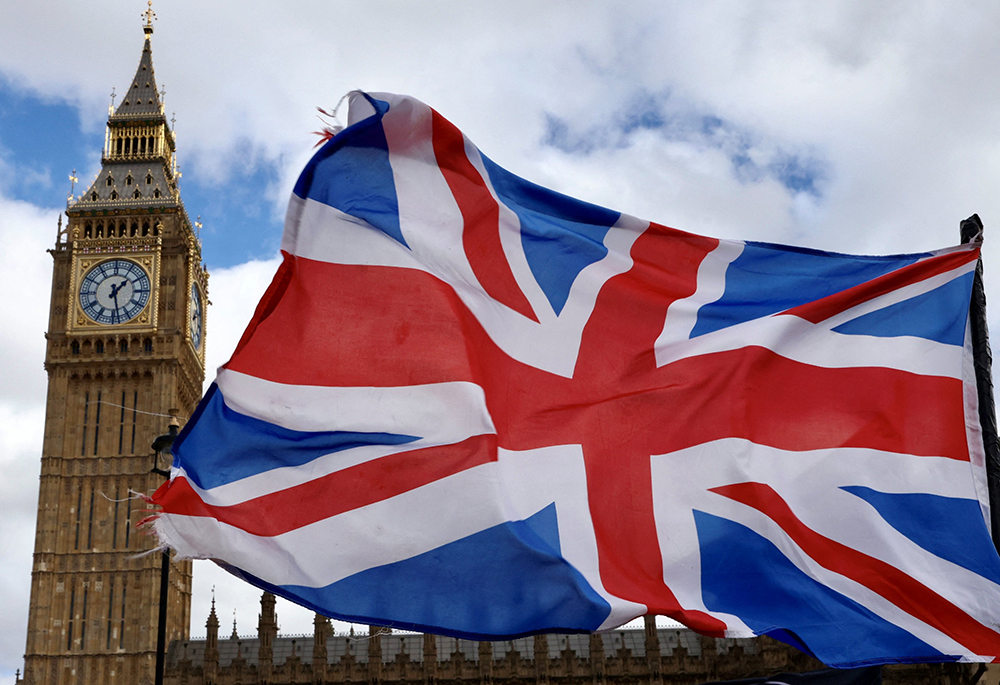 A Union Jack flag flutters in the wind near Big Ben and Parliament in Parliament Square, March 29, 2024, in London. (OSV News photo/Reuters/Kevin Coombs)