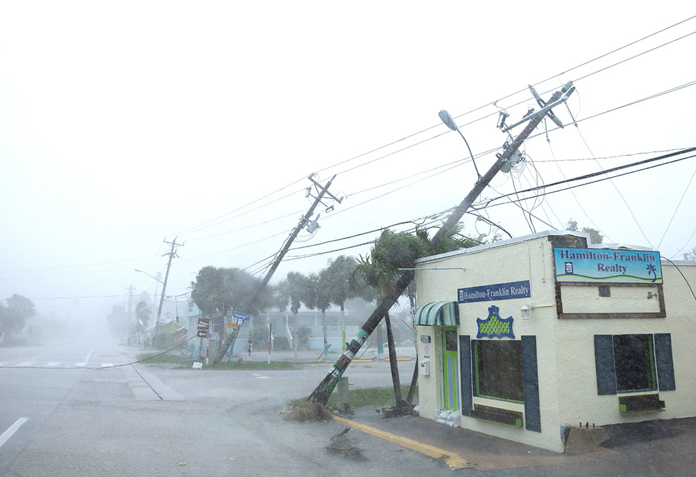 Broken utility poles downed by strong wind gusts are seen as Hurricane Milton approaches Fort Myers, Florida, on Oct. 9. (OSV News/Reuters/Ricardo Arduengo)