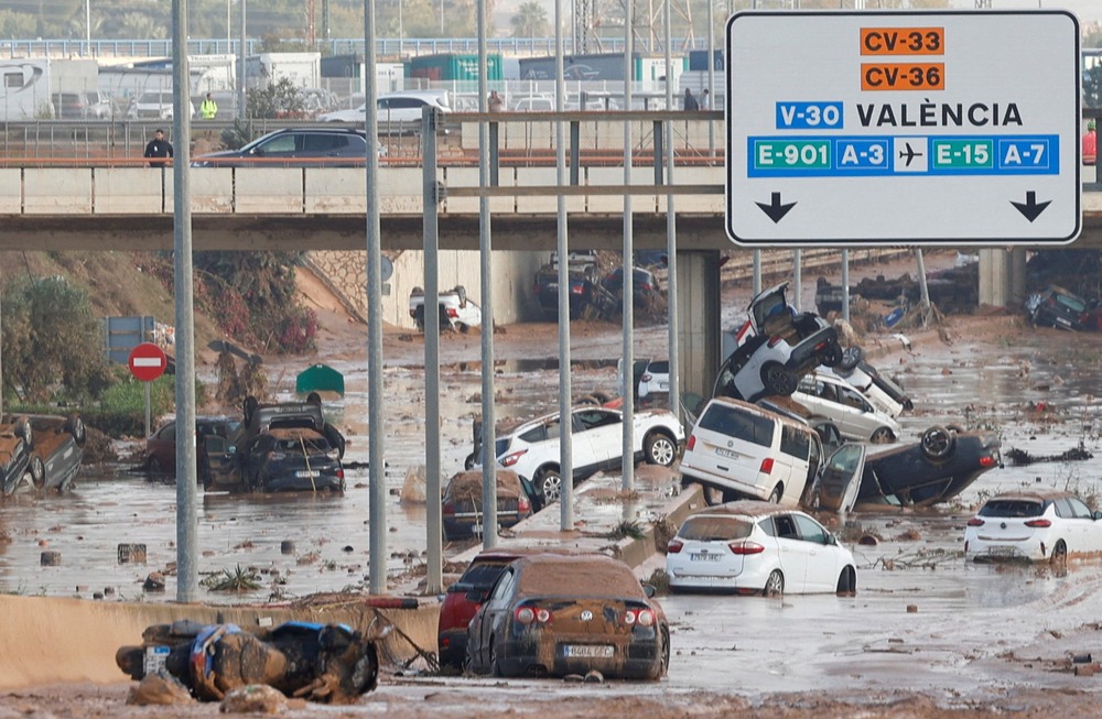 Aftermath of storm Dana flooding, Valencia, Spain, Oct. 31, 2024. What appears to be an eight-lane highway is covered with mud and abandoned, overturned cars.