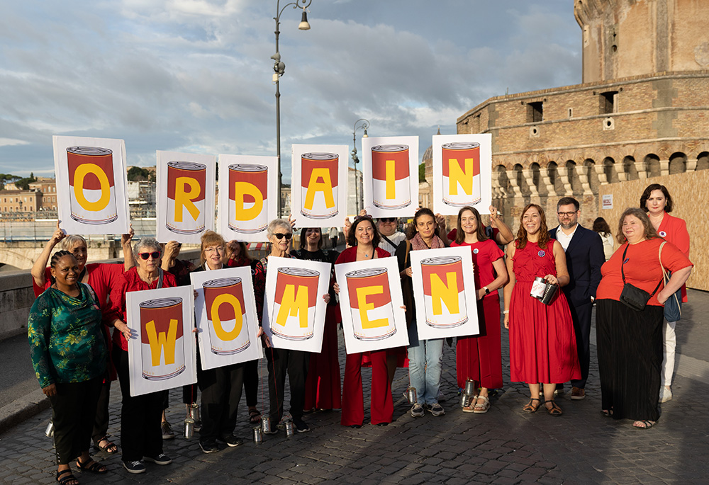 Activists from the Women's Ordination Conference hold a witness on the opening day of the synod on synodality, Oct. 2, in sight of the Vatican with the message "Don't kick the can down the road." The final document did not call for movement on the issue of women deacons but it kept the issue open. (Courtesy of Women's Ordination Conference)