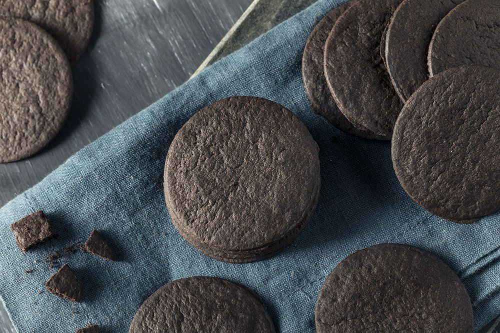 Chocolate wafer cookies on a blue cloth and a wooden table (Dreamstime/Bhofack2)