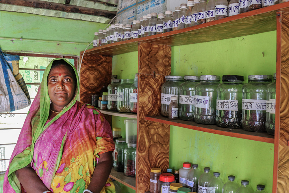 Alpana Rani Mistry shows her seed bank, about 400 species of different crop seeds and 160 species of indigenous rice seeds in reserve. (Photo by Stephan Uttom Rozario)