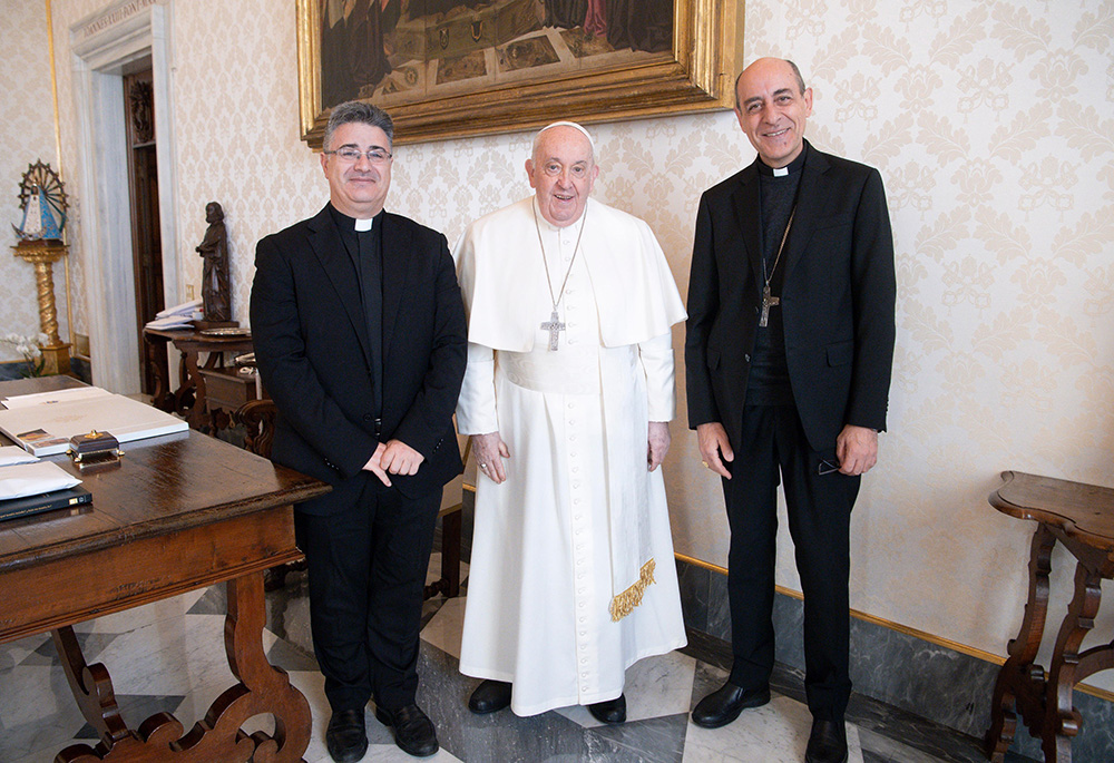 Pope Francis poses for a photo with Msgr. Armando Matteo, left, secretary of the doctrinal section of the Dicastery for the Doctrine of the Faith, and Cardinal Víctor Manuel Fernández, dicastery prefect, during a meeting at the Vatican on Dec. 18, 2023, the date Fiducia Supplicans was released for publication. (CNS/Vatican Media)