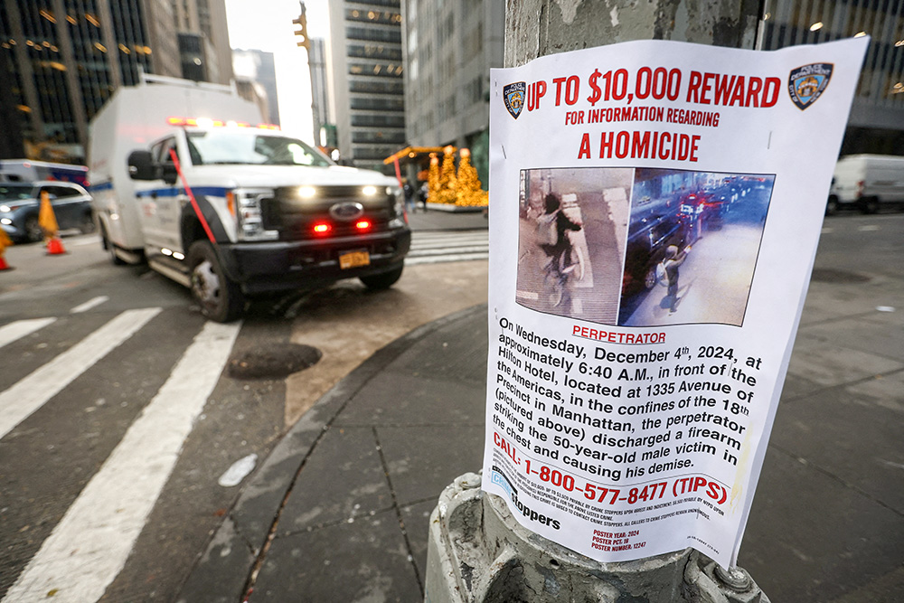 A poster is seen Dec. 5 attached to a lamppost outside the Hilton hotel near the scene where the CEO of UnitedHealthcare Brian Thompson was ambushed and shot dead the day before in New York City's midtown Manhattan neighborhood. (OSV News/Reuters/Mike Segar)