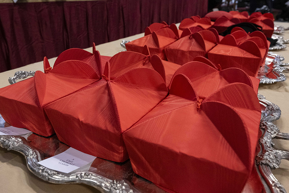 Red birettas, a three-pointed hat, sit on a table in St. Peter's Basilica at the Vatican Dec. 7 before Pope Francis' consistory to create new cardinals. (CNS/Vatican Media)