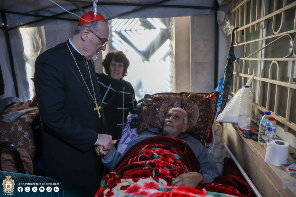 Cardinal Pierbattista Pizzaballa is seen Dec. 22, 2024, visiting an elderly Palestinian man sheltering on the premises of Holy Family Catholic Parish in Gaza City in the war-torn Gaza Strip. The cardinal made a pre-Christmas visit aiming to bring the joy of the season to the suffering Christian community in the 14th month of Israel-Hamas war. (OSV News photo/courtesy Latin Patriarchate of Jerusalem)