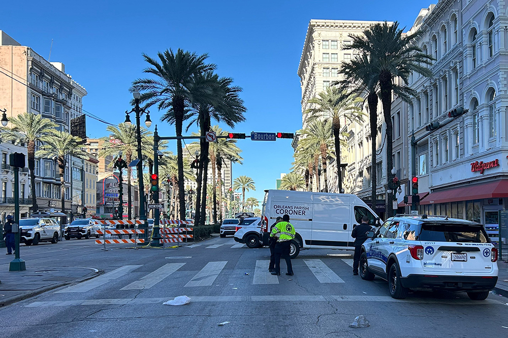 An Orleans Parish coroner's van is parked at the corner of Bourbon and Canal streets after a pickup truck drove into a large crowd in the French Quarter of New Orleans Jan. 1, 2025. (OSV News/Reuters/Brian Thevenot)