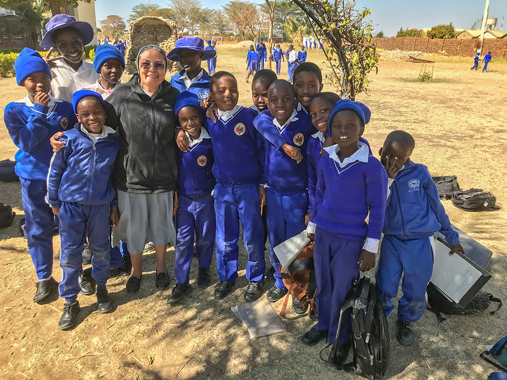 Our Lady of Sorrows Sr. Delnise Silva shares a light moment with children from Our Lady of Sorrows Primary School in rural Zimbabwe. (Marko Phiri)