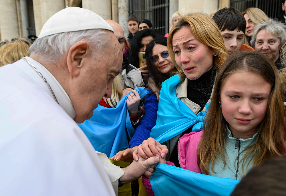 Pope Francis greets Ukrainian refugees after his weekly general audience in St. Peter's Square at the Vatican March 8, 2023. (CNS/Vatican Media)