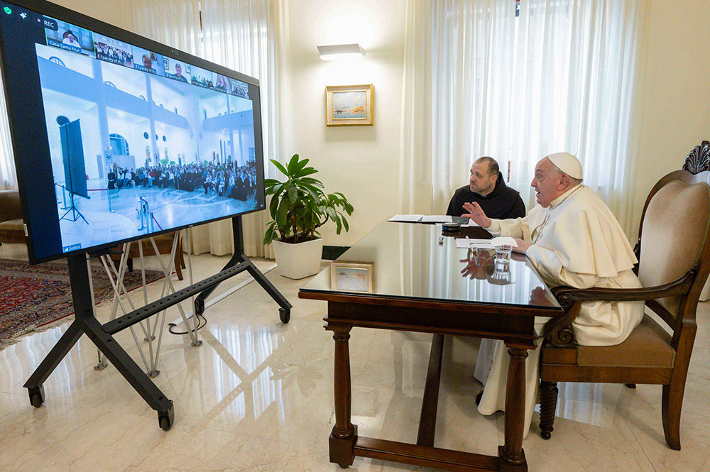 Pope Francis waves to young people gathered in the Ukrainian Greek Catholic Cathedral of the Resurrection in Kyiv during an online meeting Feb. 1, 2025. (CNS/Vatican Media)