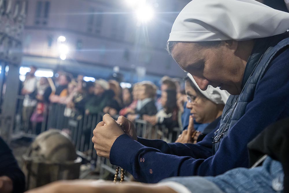 People gather to pray the rosary for the repose of the soul of Pope Francis April 24, 2025, at Rome's Basilica of St. Mary Major. (CNS/Pablo Esparza)