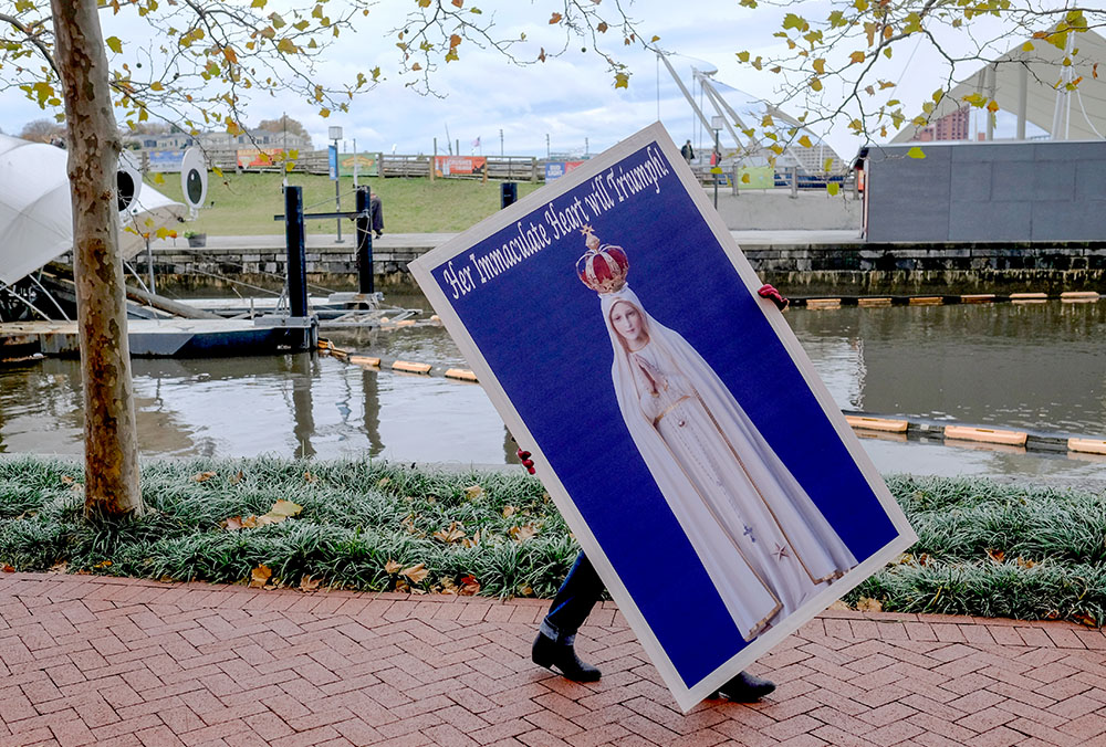 A protester carries a placard Nov. 13, 2018, for a rally sponsored by Church Militant in Baltimore. (CNS/Tennessee Register/Rick Musacchio)