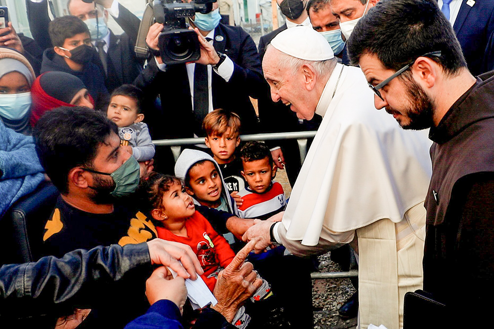 Pope Francis meets migrants during his visit to the Mavrovouni camp for refugees and migrants on the island of Lesbos, Greece, Dec. 5, 2021. (CNS/Reuters/Guglielmo Mangiapane)
