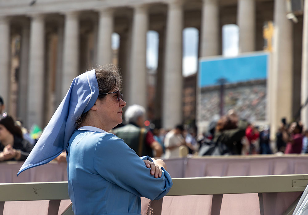 A religious sister waits in St. Peter's Square May 8, 2025, on the second day of the conclave at the Vatican. (CNS photo/Pablo Esparza)