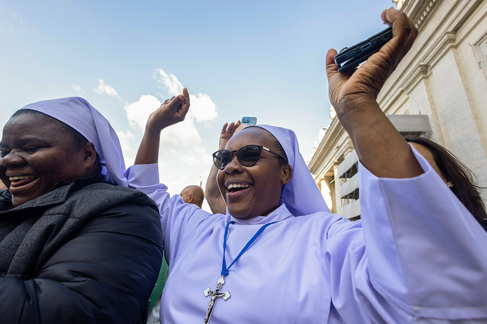 Crowds cheer in St. Peter's Square as white smoke emerges from the chimney atop the Sistine Chapel at the Vatican May 8, 2025, indicating Pope Leo XIV, the former Cardinal Robert Prevost, was elected pope. (CNS/Pablo Esparza)