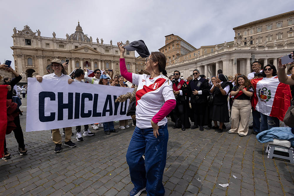 People from Peru hold up a banner saying Chiclayo, the diocese in Peru where the new Pope Leo XIV served as bishop from 2015 to 2023, as they join the pope for the 'Regina Coeli' prayer in St. Peter's Square at the Vatican May 11, 2025. (CNS/Pablo Esparza)